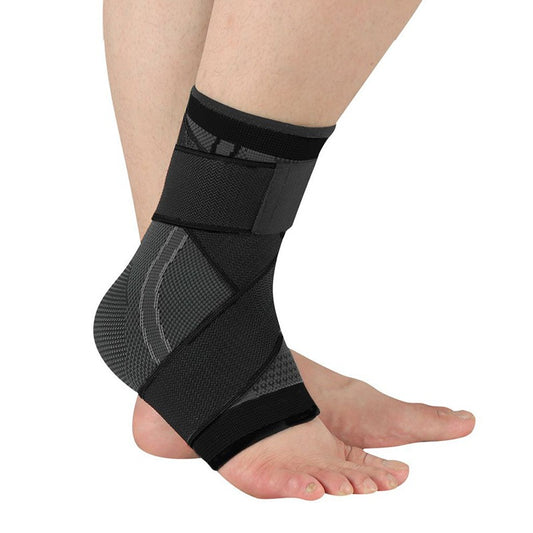 Kindheel arch-strap compression sleeve in black with grey stripes, worn on the foot, strap wrapped under the arch and around the ankle